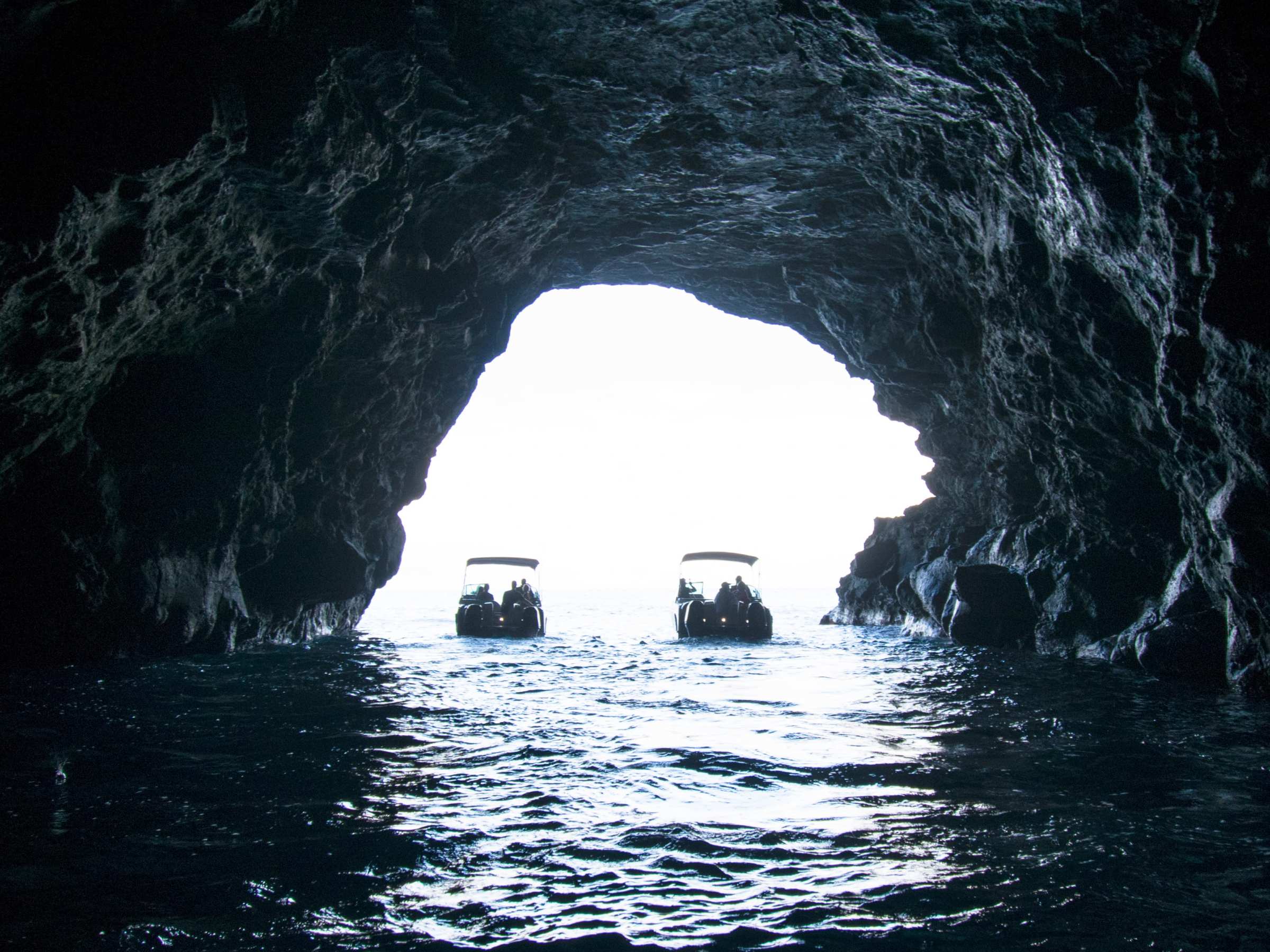 a cave next to a body of water