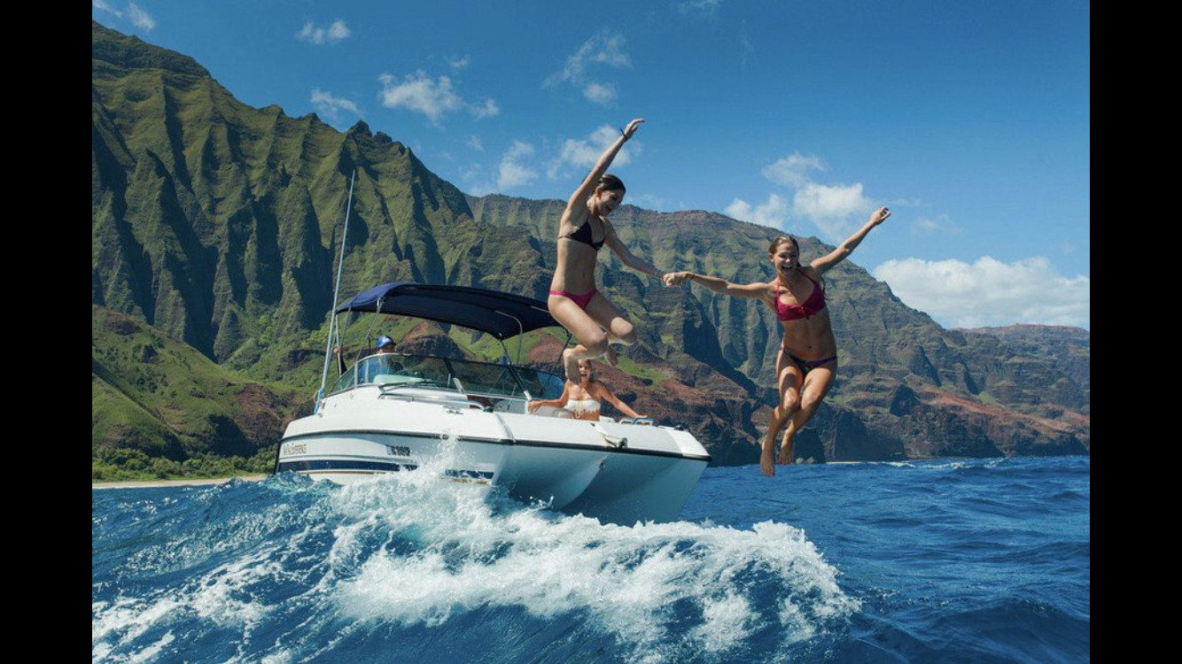 a person riding on the back of a boat in the water